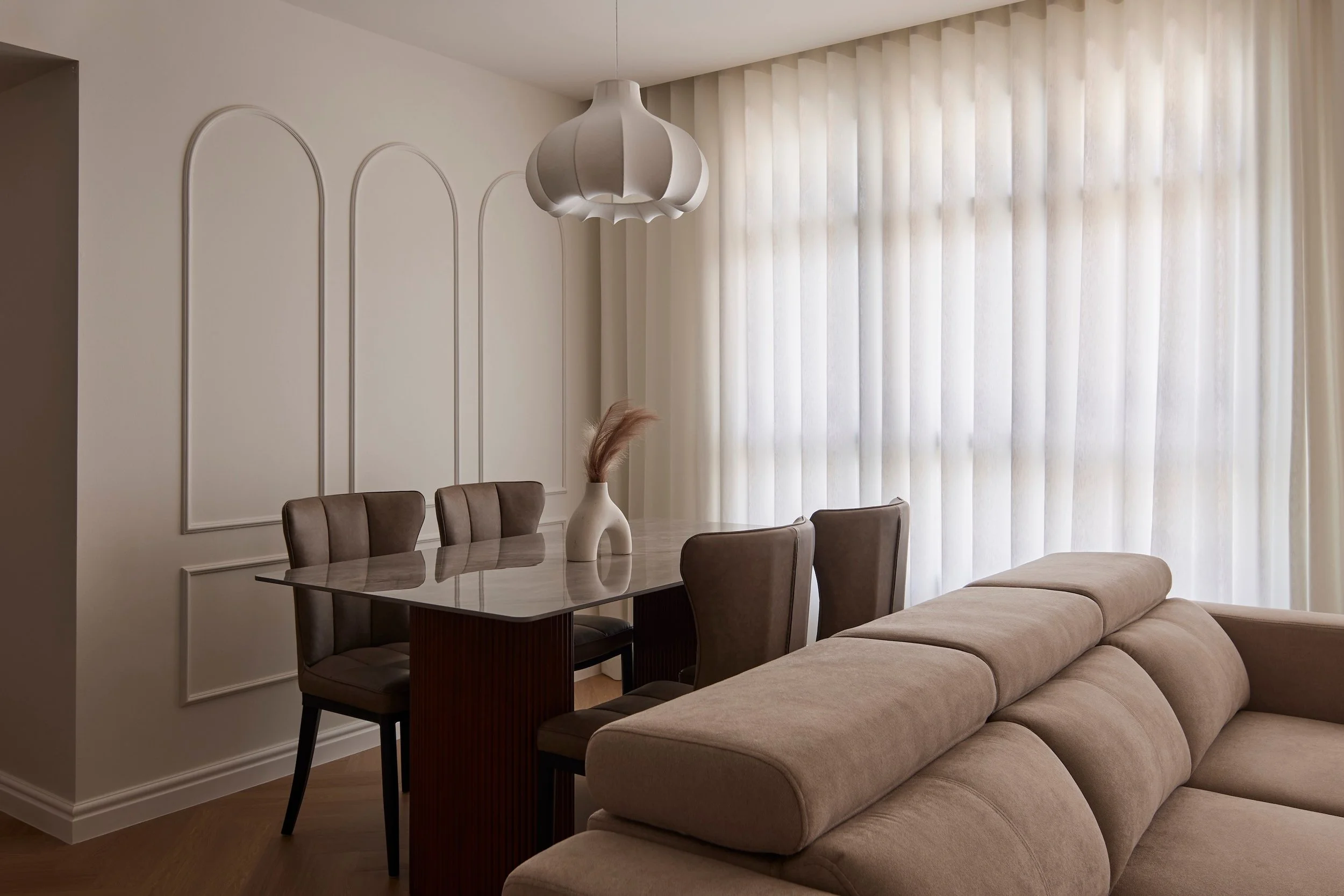 Do you notice all the vertical lines here?

It's on the ripple fold curtains, the paper texture dining light, the beading on the wall. It's also on the dining chairs and the sofa.

We like how soothing and spacious it is overall.

The clients also ch