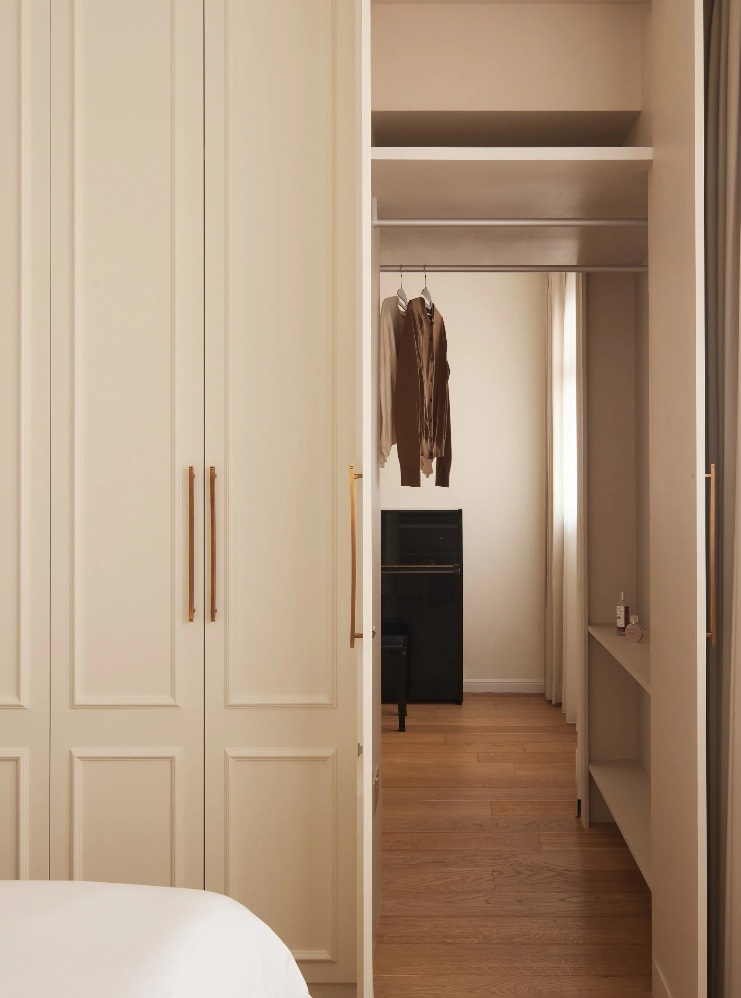 You've probably heard of walk-in wardrobes. How about wardrobes you can walk through?

In this 4-room BTO, the wall between two rooms was removed and replaced with this beautifully cream coloured wardrobe.

The first four doors is a regular wardrobe.