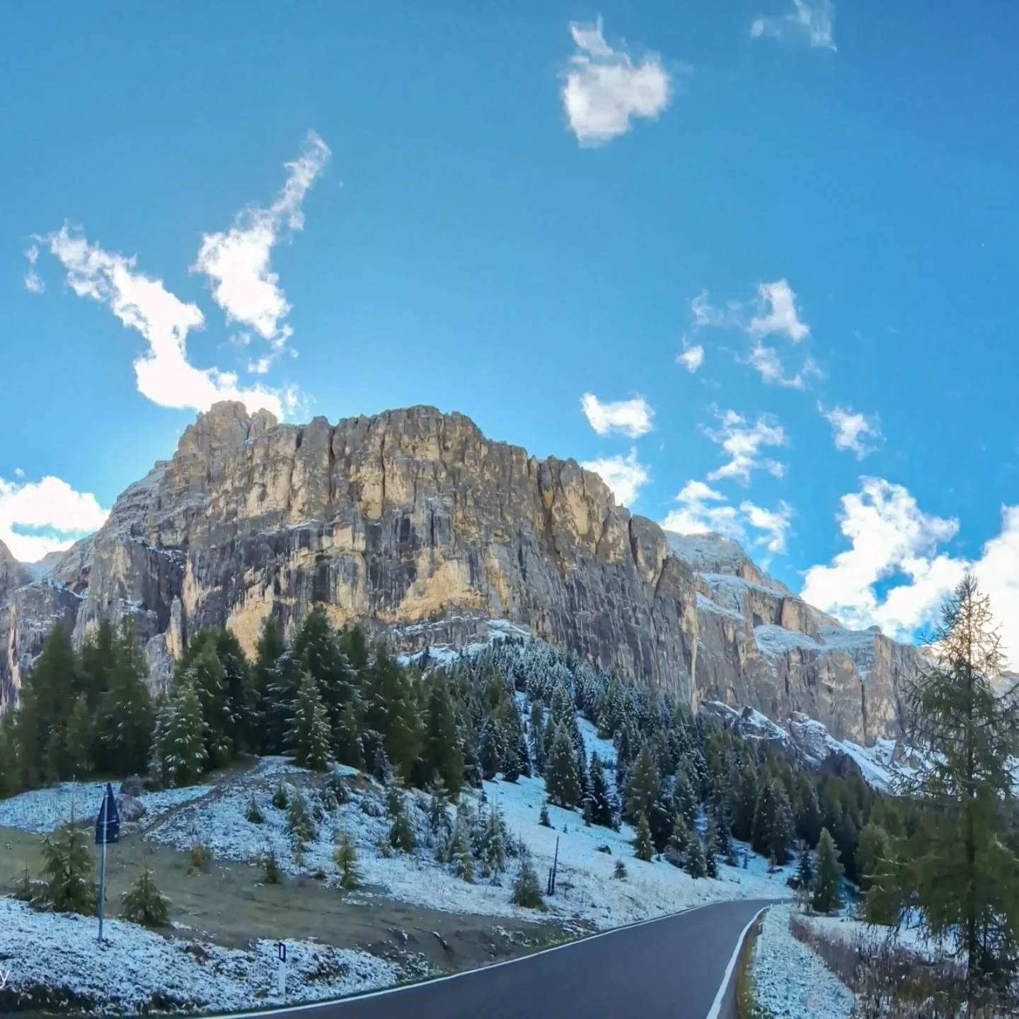 The Sella and Sassolungo mountain range
.
Amazing views, driving across the Passo Sella (Sella Pass). This is a famous high 
mountain pass in the Dolomites, Italy, connecting Val Gardena and Val di Fassa. 
There are lots of mountain passes with lo