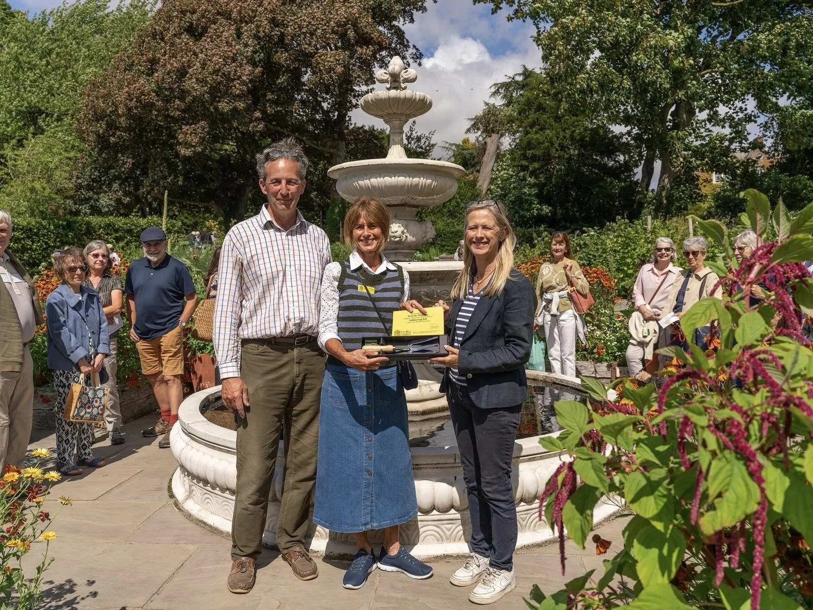 Mark and Clare Oglesby of Goldsborough Hall being awarded a certificate and trowel to celebrate 20 years of NGS garden openings