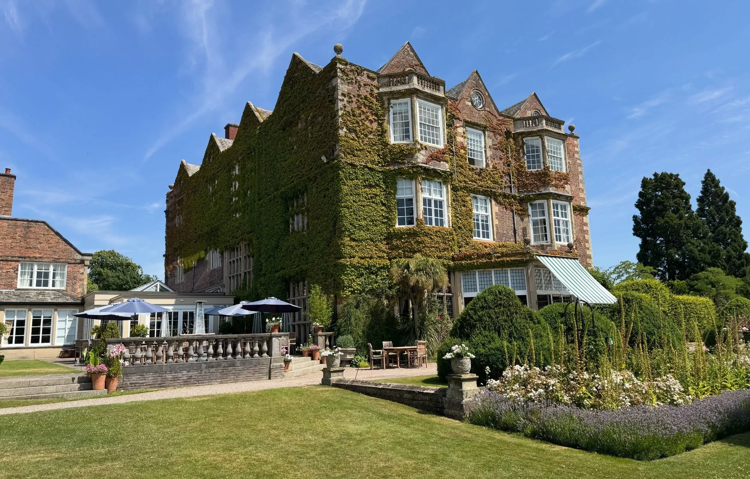 Colour image of Goldsborough Hall, North Yorkshire taken from the south side showing the afternoon tea terrace and lavender and rose border