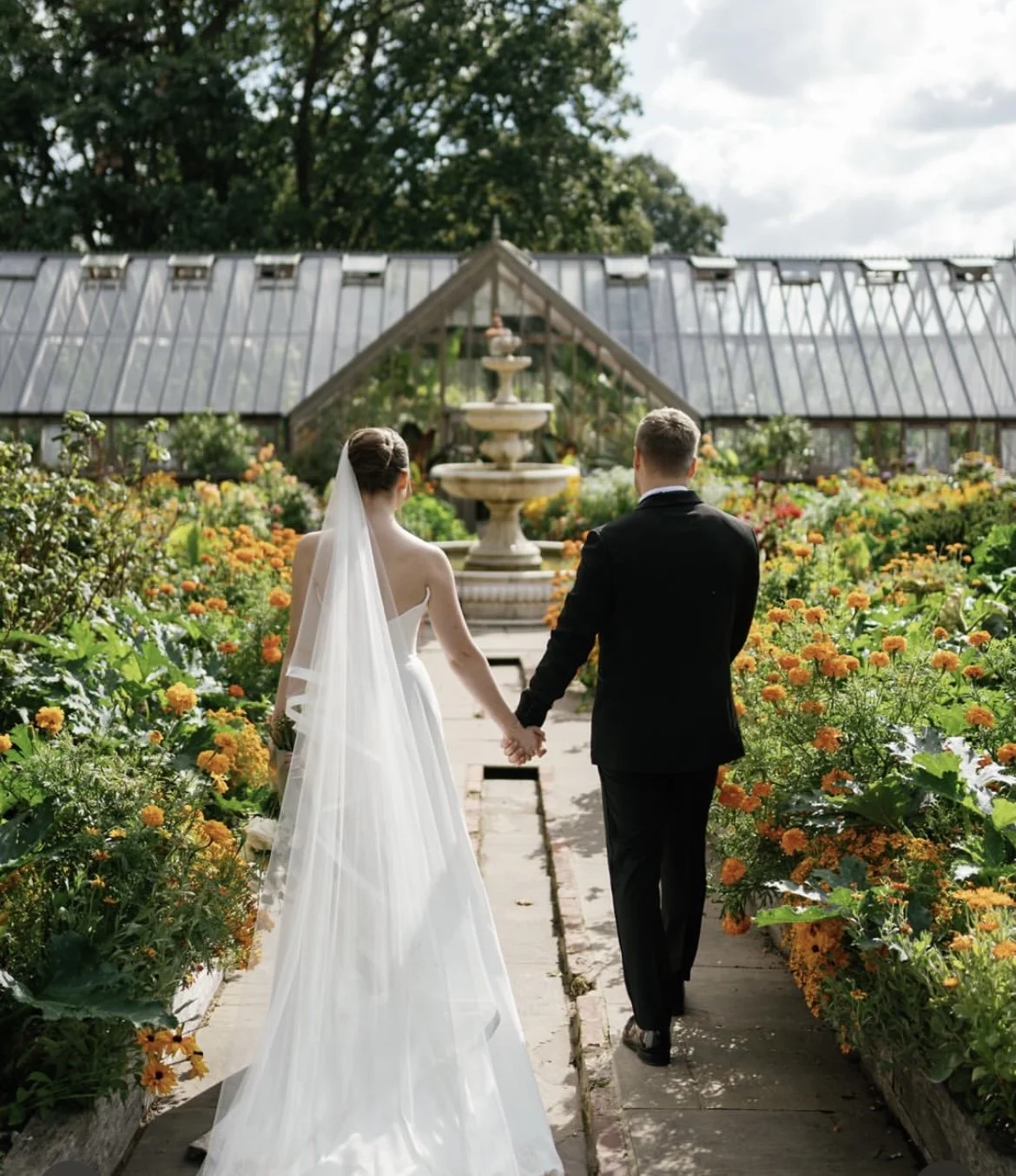 Wedding couple walking in the kitchen garden at Goldsborough Hall