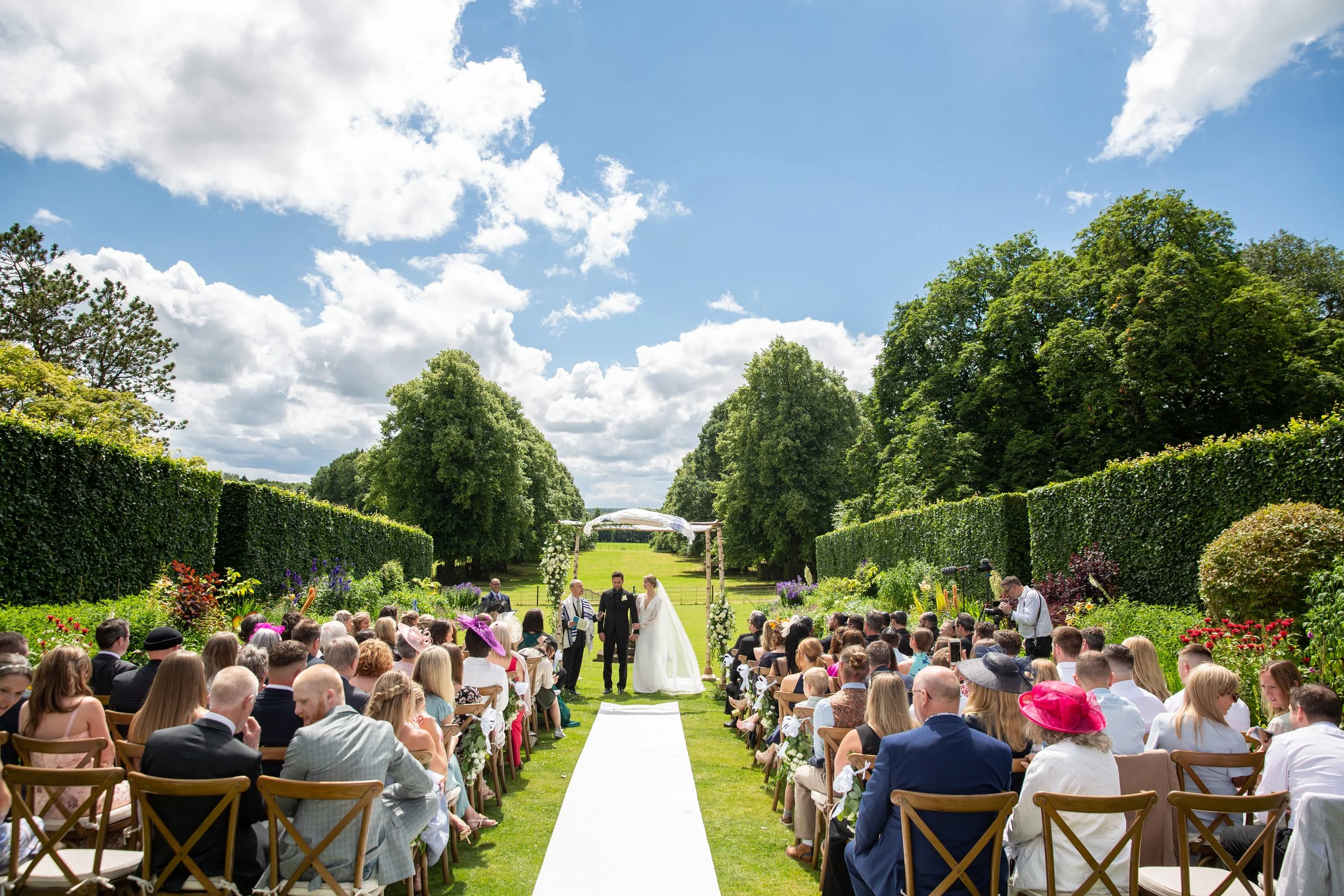 Guests and the wedding couple for an outdoor wedding at Goldsborough Hall