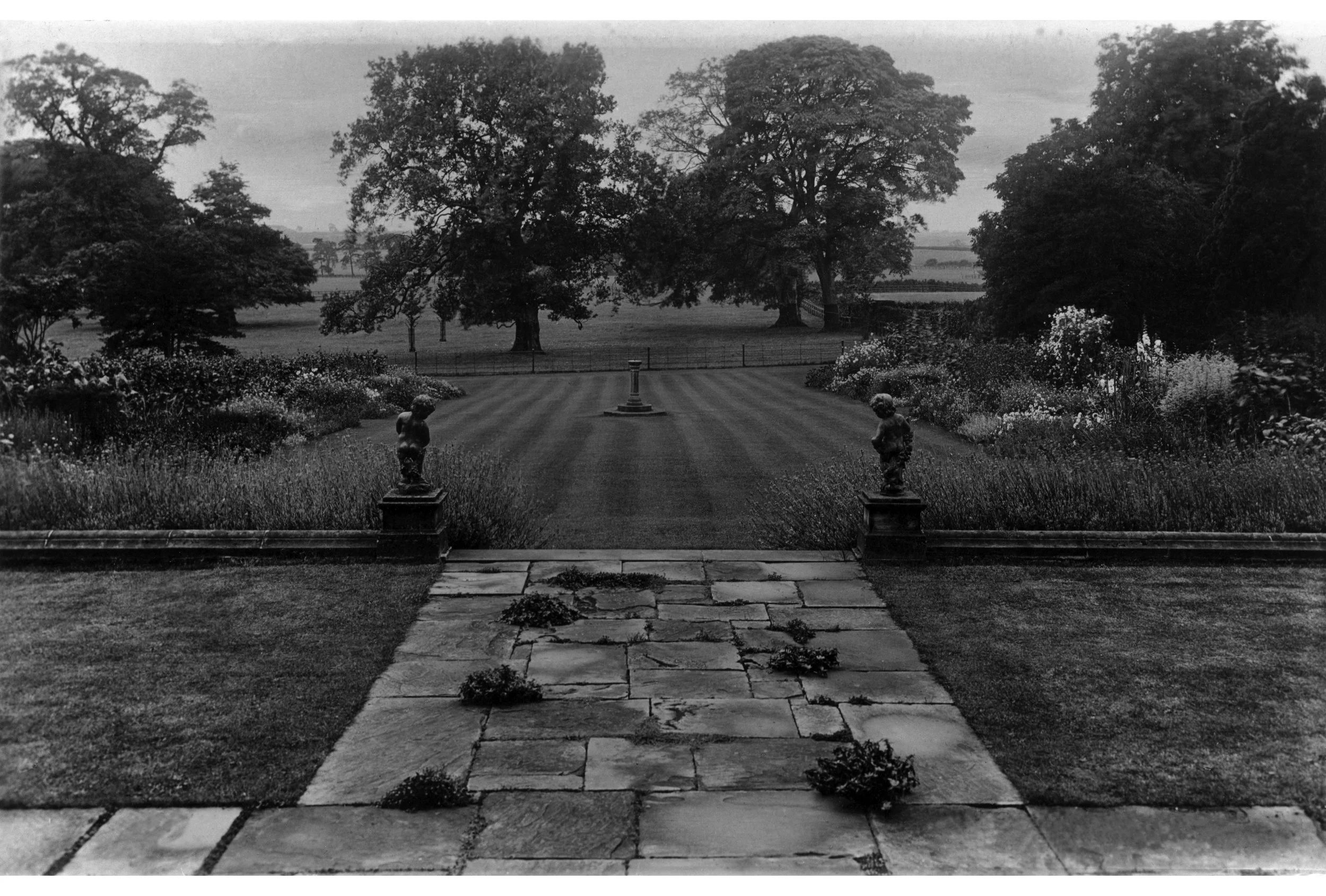 Black and white image of Goldsborough Hall's gardens from 1920s with a view looking down the main borders