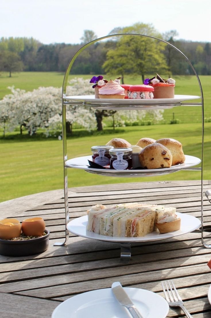 Royal afternoon tea served on the terrace with spring blossom in the background