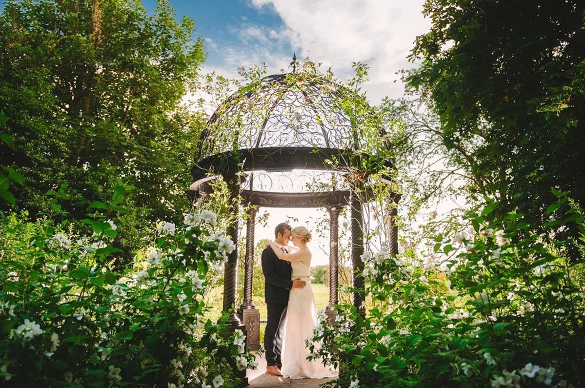 Wedding couple at the gazebo at venue Goldsborough Hall