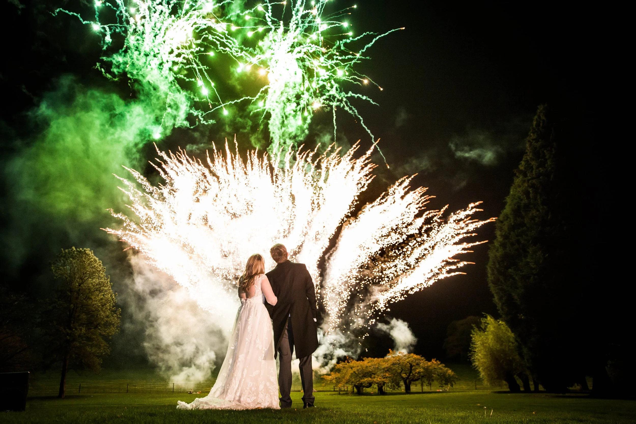wedding couple watching fireworks at night at Goldsborough Hall