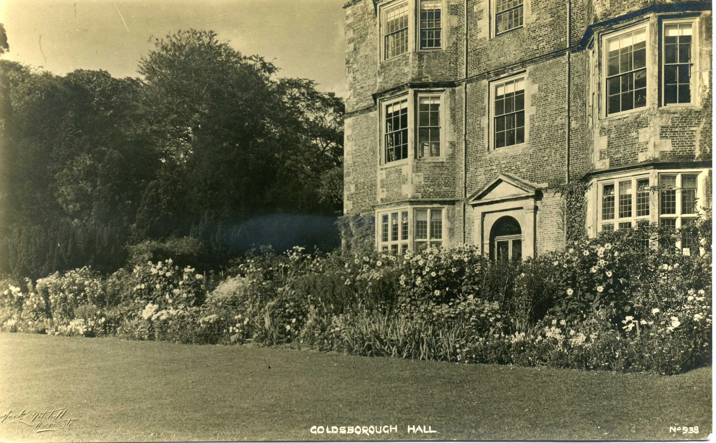 Black and white image of Goldsborough Hall, North Yorkshire with grass and plants in the foreground