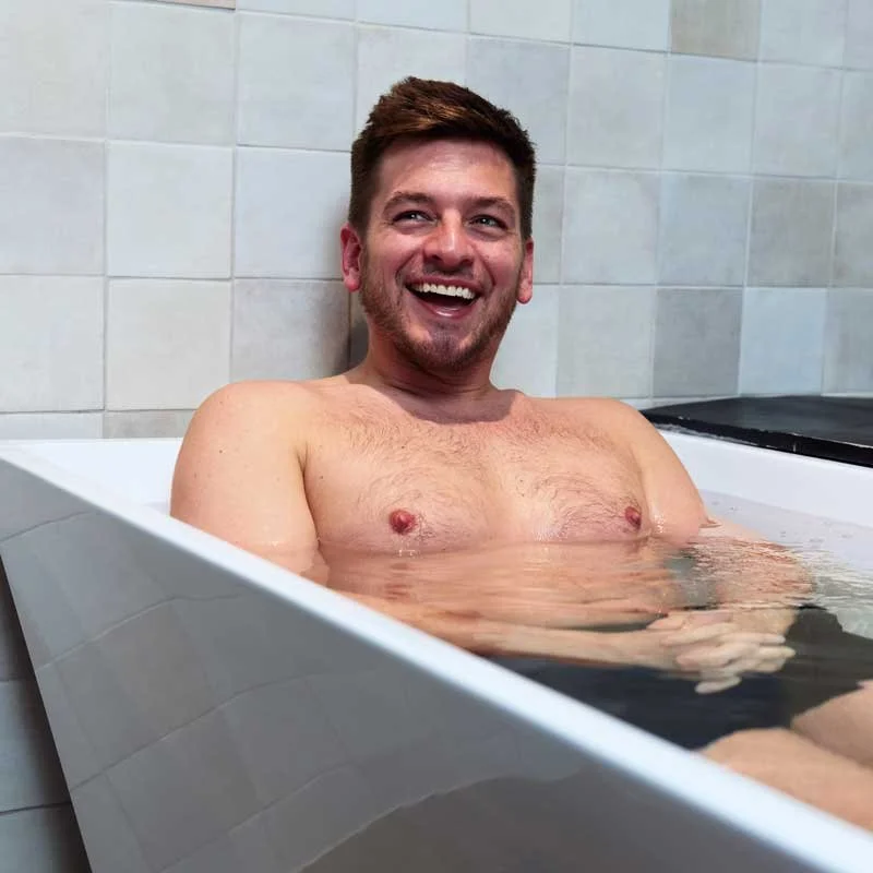 Launghing man in cold plunge tank