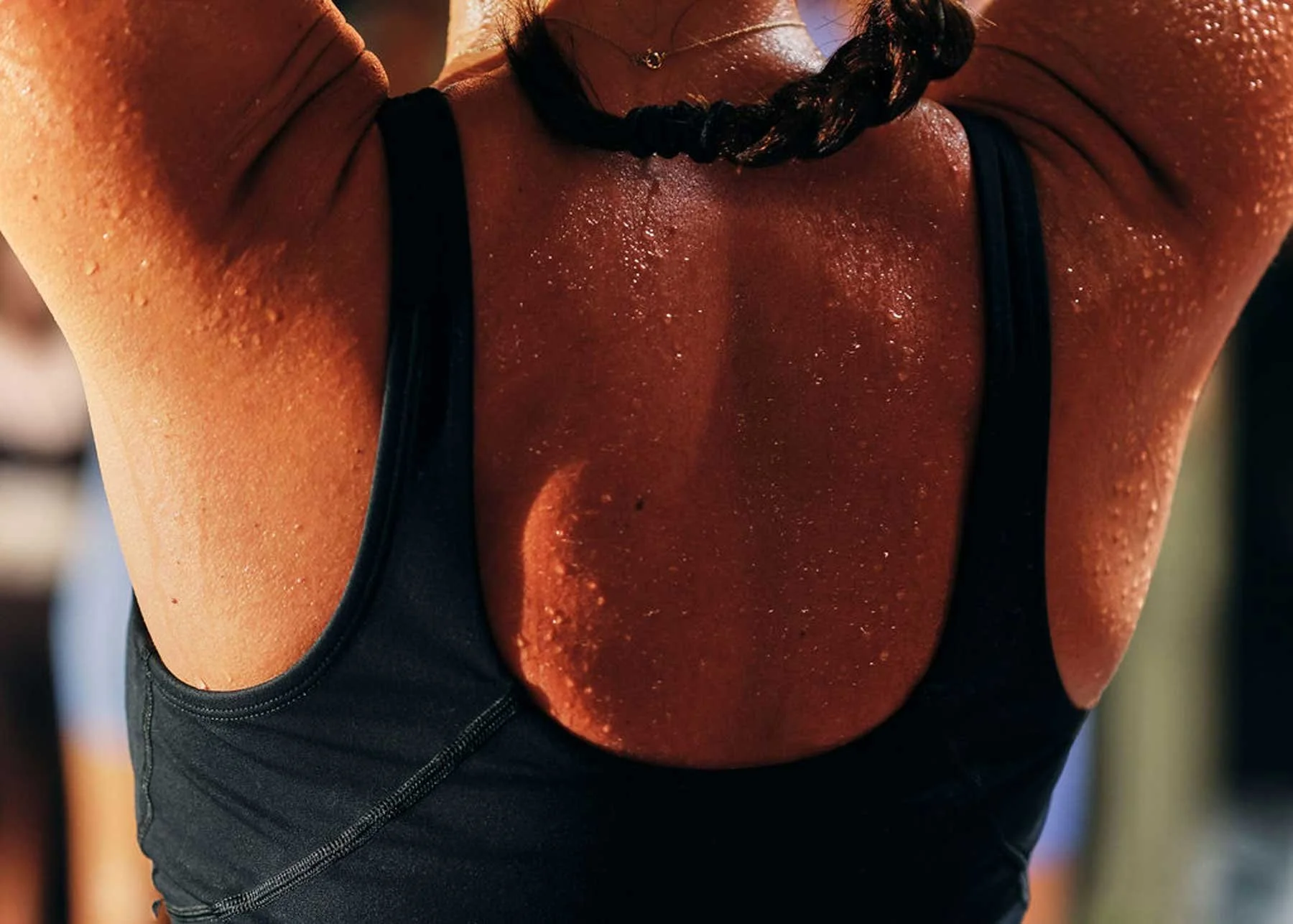 Woman's back with beads of sweat