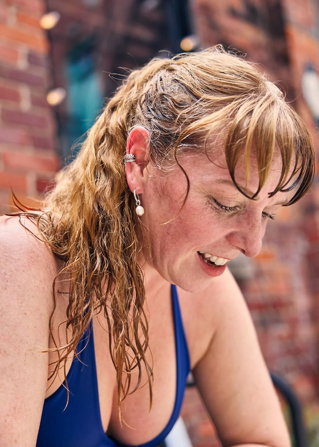 woman with ponytail in workout top sweating after yoga