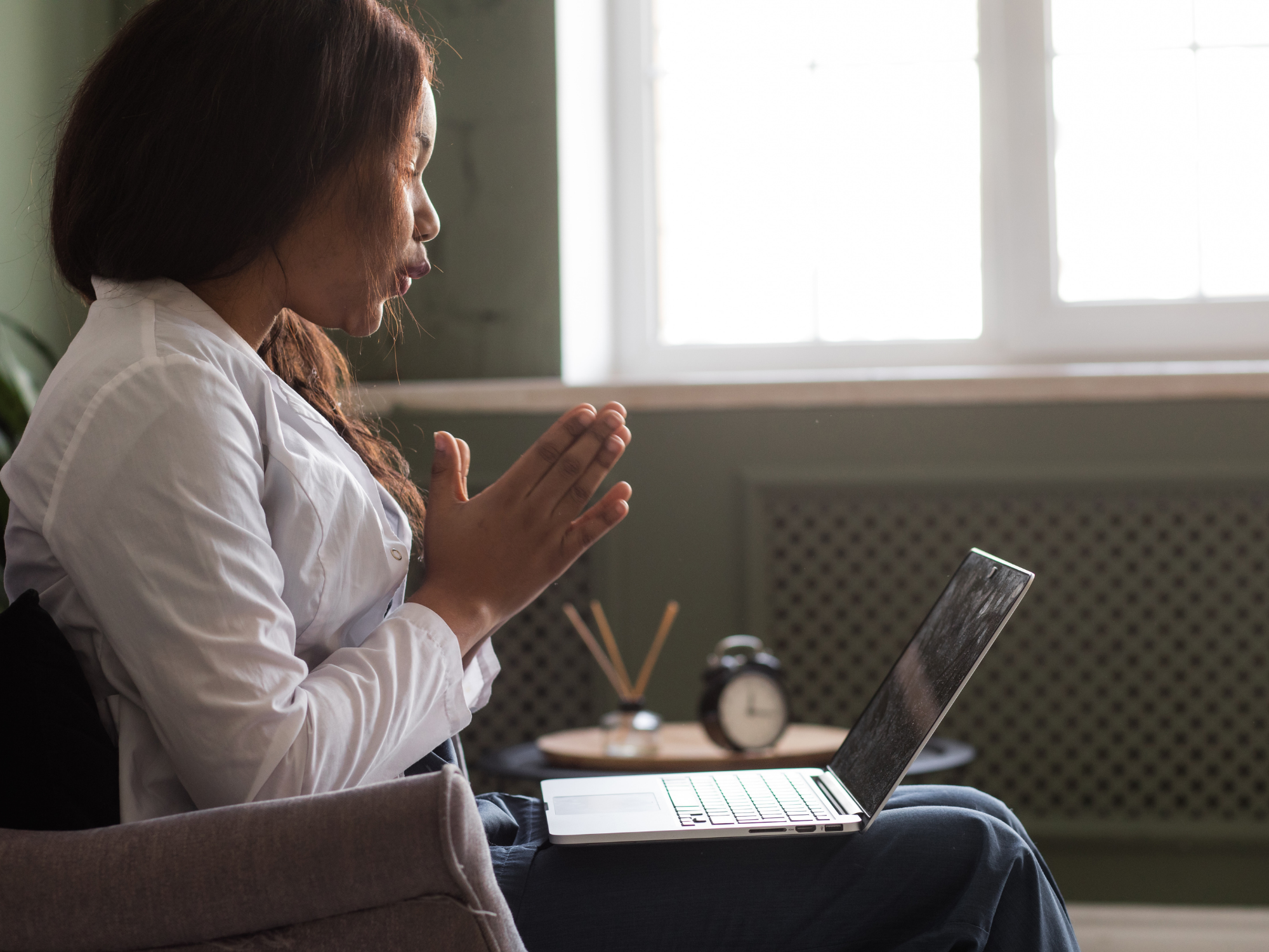 Woman talking during online therapy with SG Therapy Group Cleveland