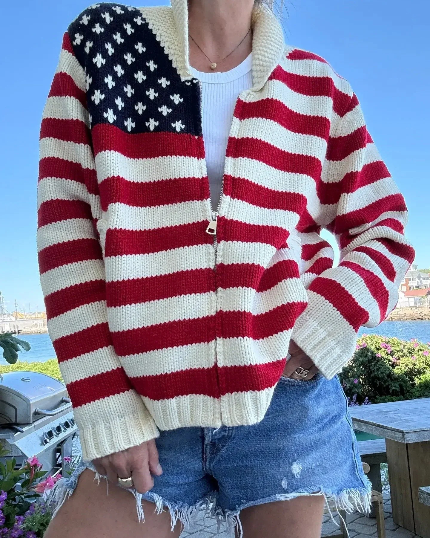 Sweater season, coastal edition. 🇺🇸🌊
We&rsquo;re not saying goodbye to summer. We&rsquo;re just adding a sweater. ✨

🛒 exstilla.com/sandpiper-lane/p/american-flag-varsity-cardigan-zip-up