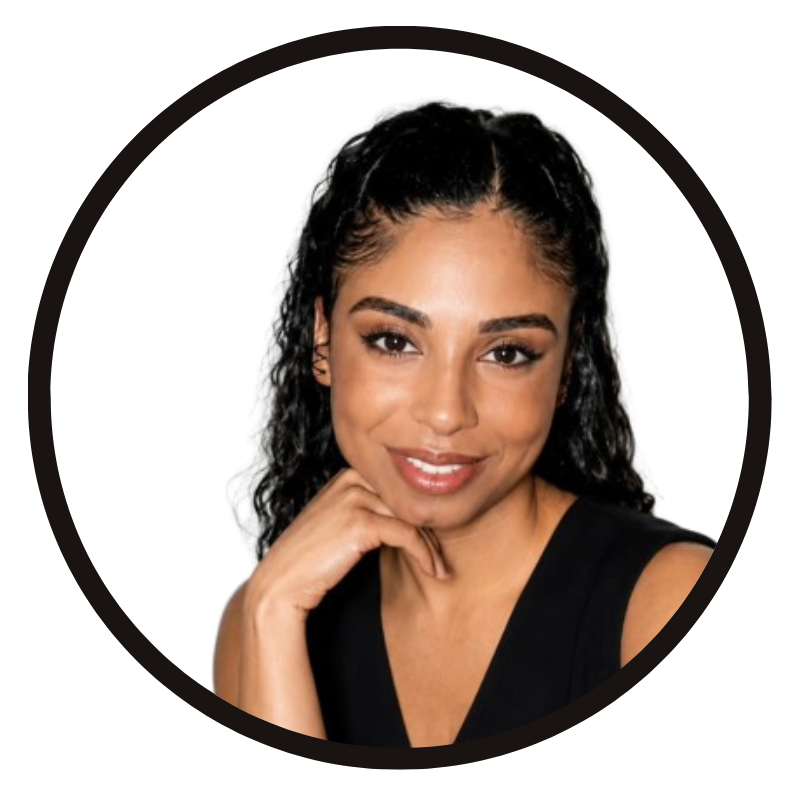 Portrait of a woman with dark, curly hair, wearing a black sleeveless top, resting her chin on her hand, smiling gently against a white background.