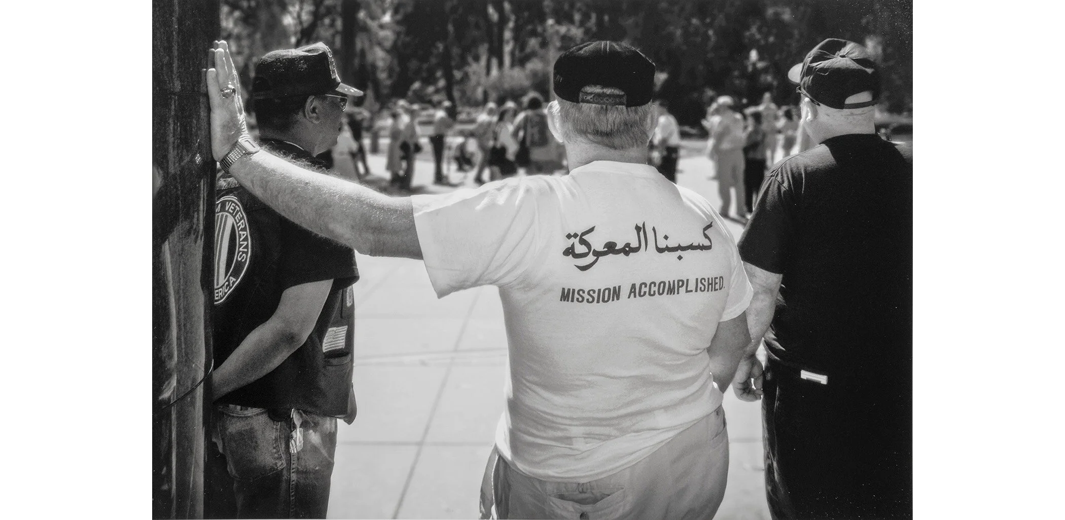 Three Vietnam-era veterans stand in front of the Vietnam Memorial in Capitol Park during an anti-war demonstration. The pro-war veterans insisted the demonstration be moved back away from the memorial entrance, while they stood guard in nonchalant si