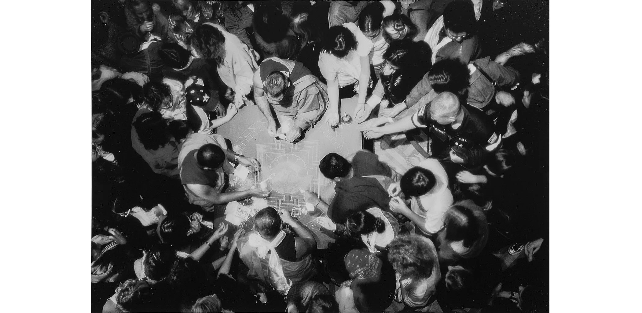 ...the sand painting and prepared to cast it into the Sacramento River - a symbolic evocation of the impermanence of all things. Onlookers pressed around the table to receive small token baggies of sand. Peace activists greeted each other somberly th