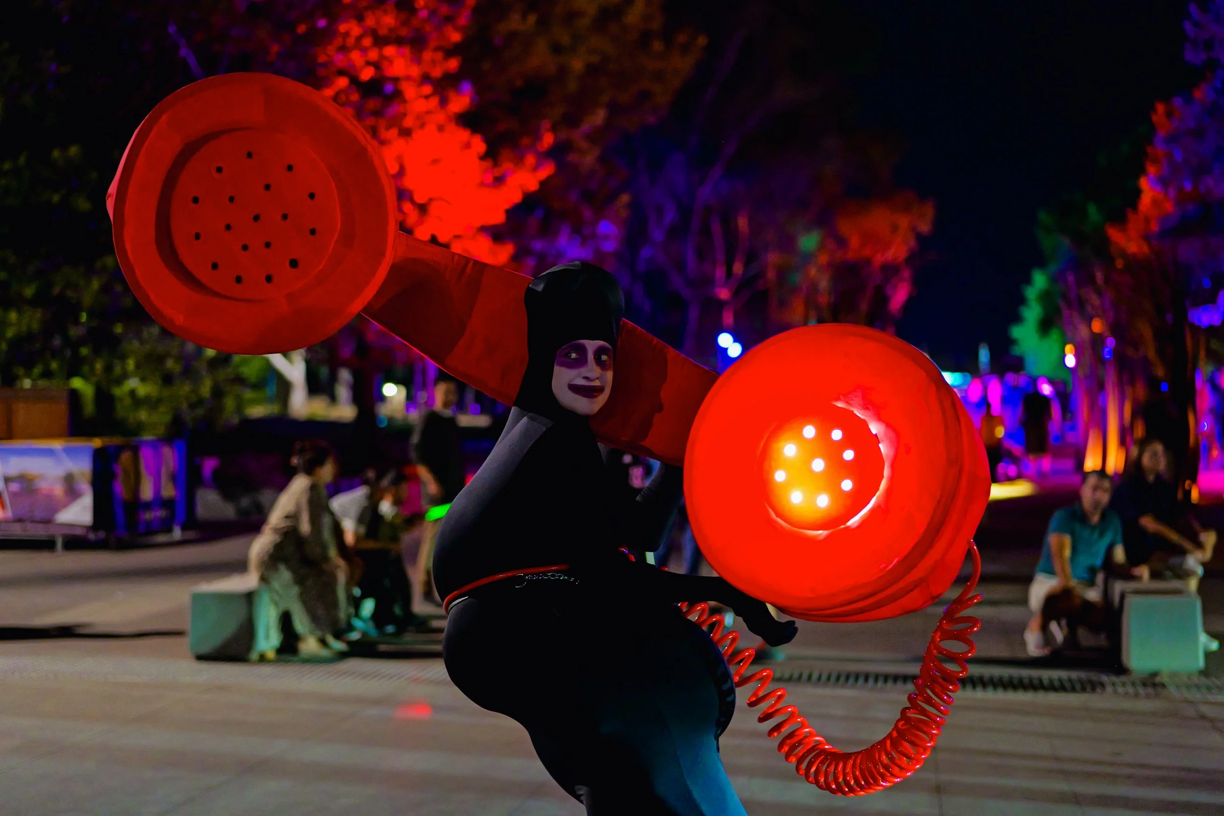 Alicia at Enlighten Festival with red telephone as Bouffon