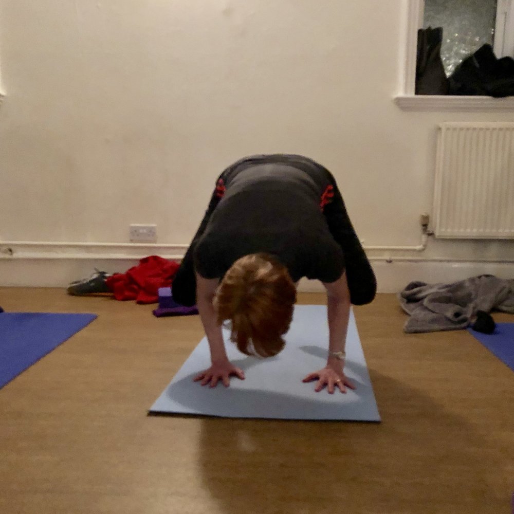 One of my lovely yoginis, Mary, taking bakasana or crow pose during my yoga classes in Hucknall Nottingham