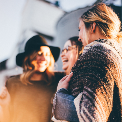 Female friends laughing, stronger together