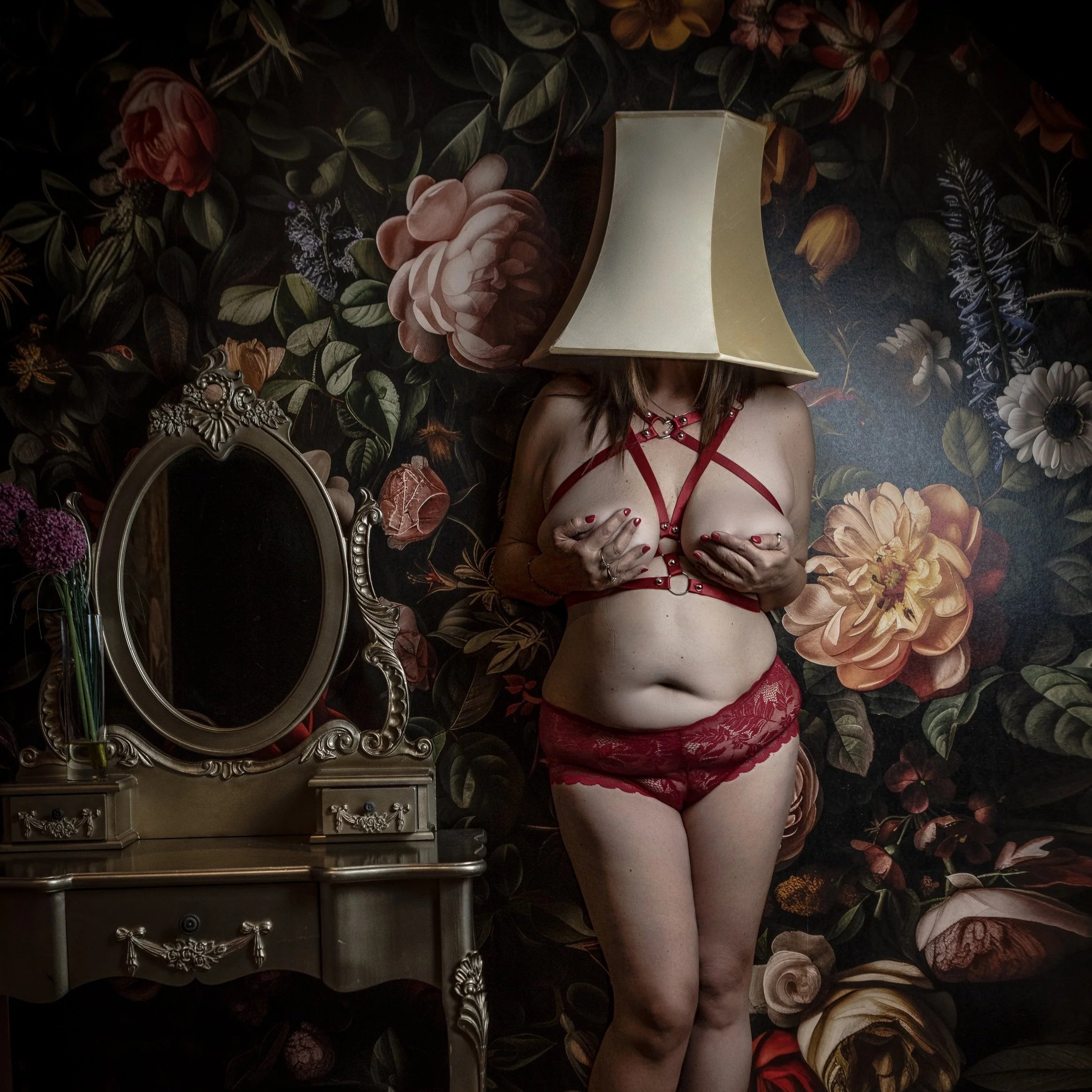 woman hiding her identity under an lampshade
