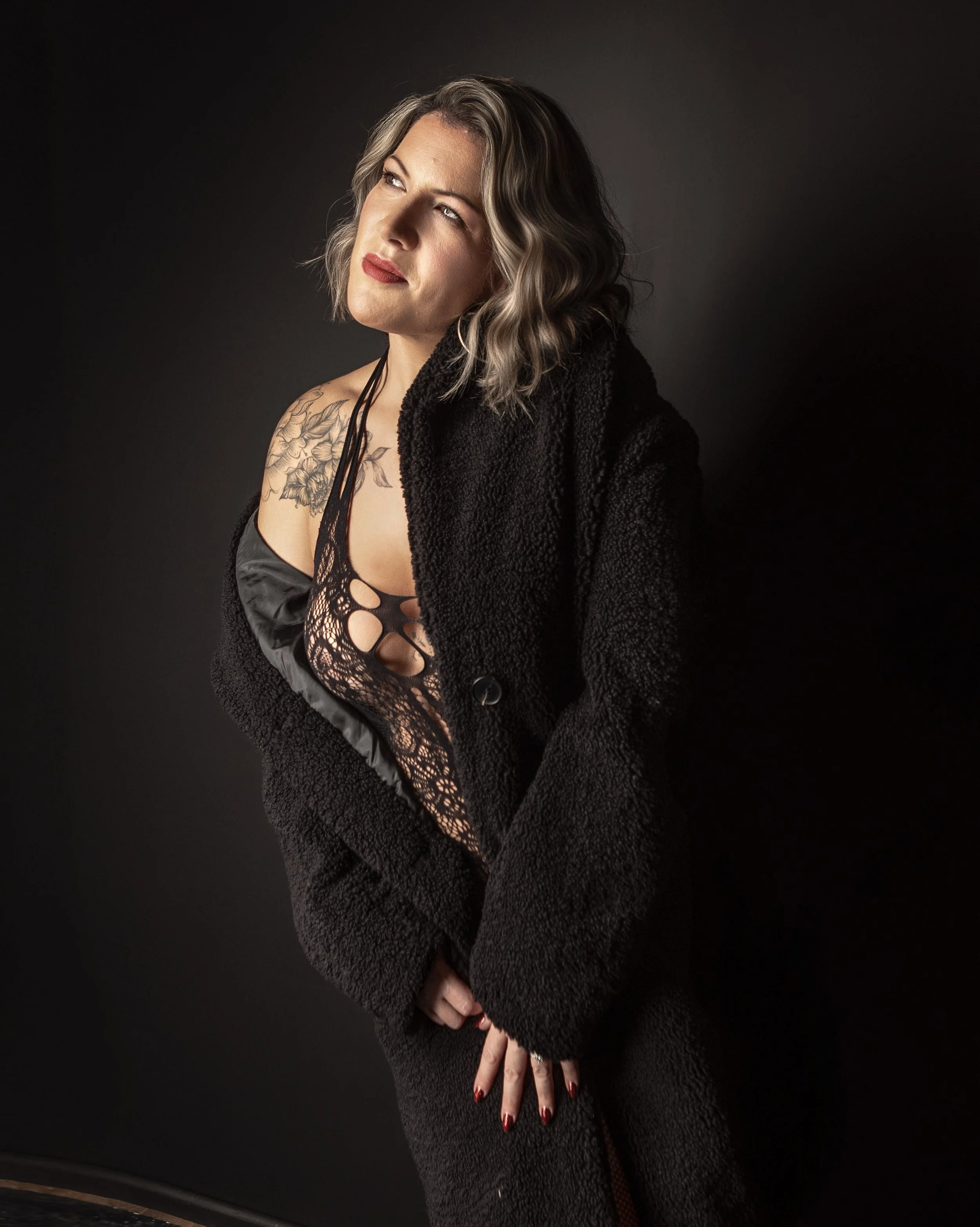 Empowering boudoir portrait in black lace celebrating weight loss, at Sarah Tate's studio in Heathfield, East Sussex