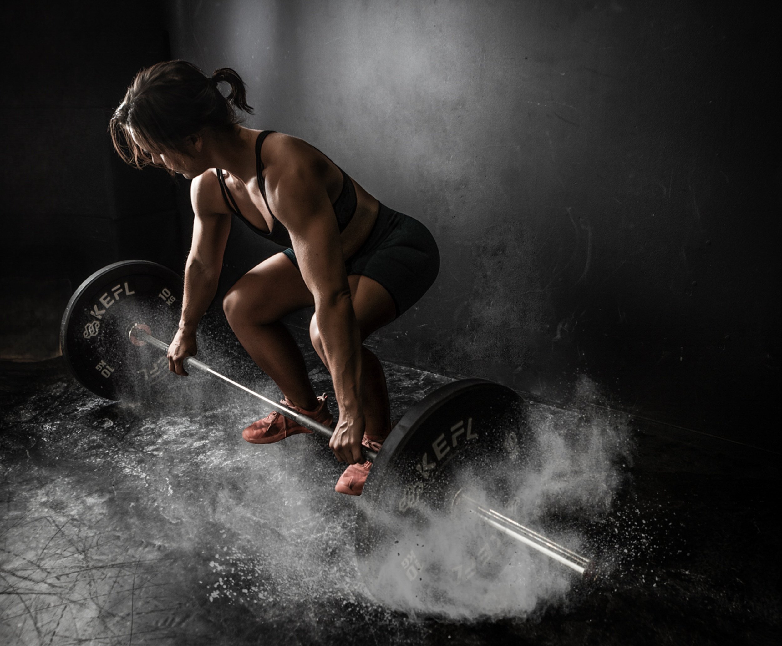 Woman lifting weights during an empowerment photoshoot in East Sussex by Boudoir by Sarah Tate Photography