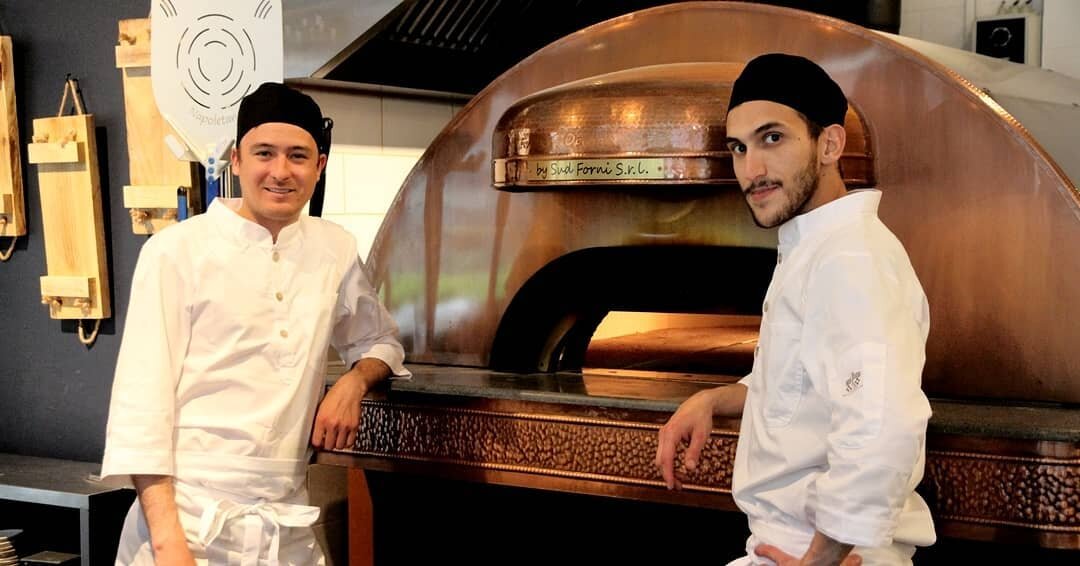What a dream team! 😍&nbsp;Our chefs Lucian and Andrea are excited to prepare your pizza and then slide it into our large brick-oven. This oven is specially made for preparing Neapolitan pizzas. Fun fact; it can heat up to 520 degrees! 🔥