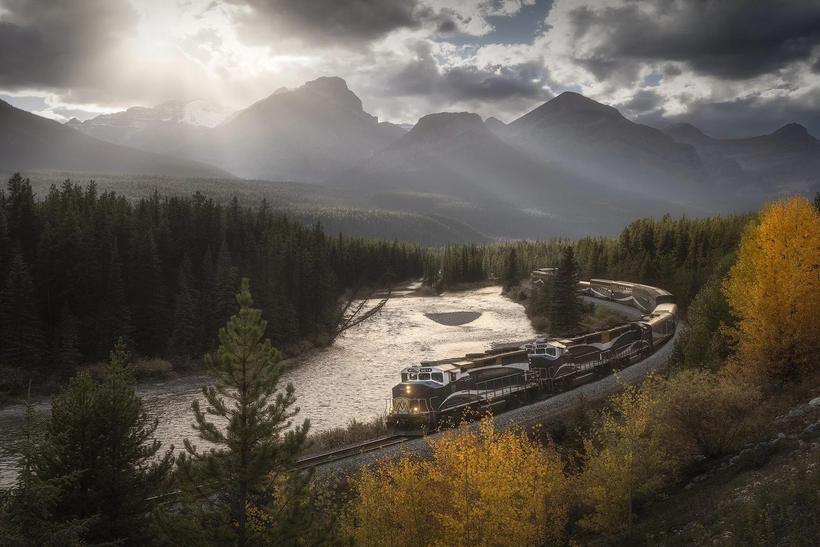 Morant’s Curve in Autumn – Rocky Mountaineer Train Along River Bend with Mountain Backdrop.jpg