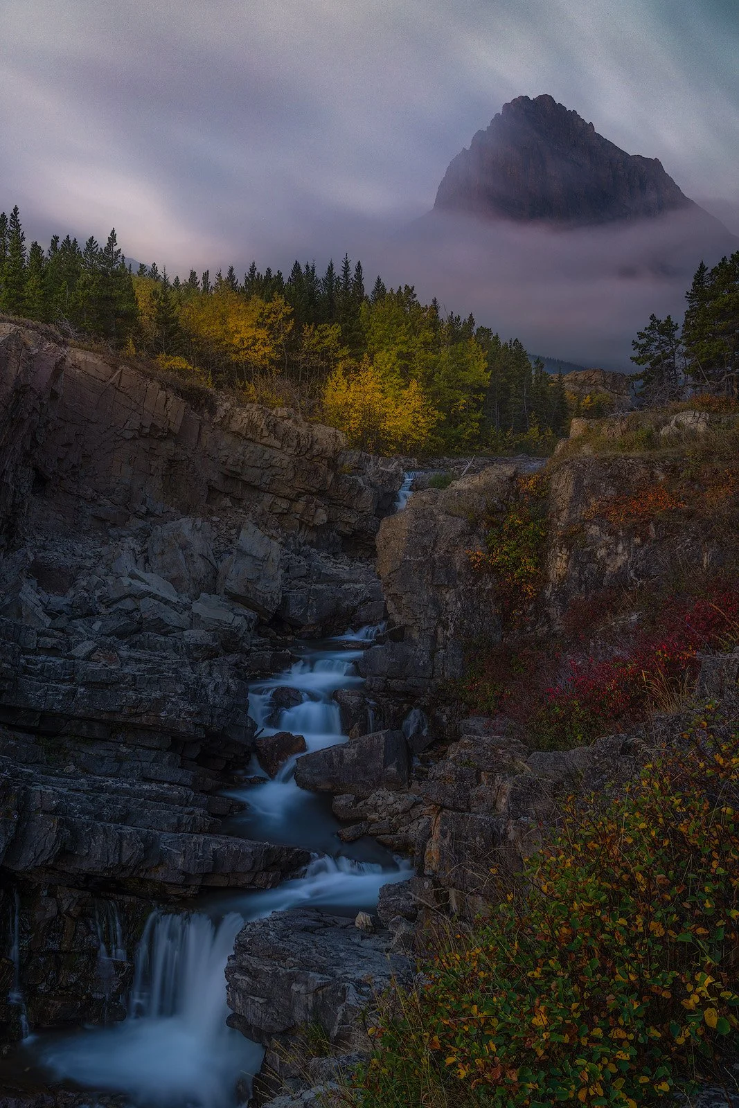 Glacier National Park – Autumn Cascade Framed by Fall Color and Misty Peak at Dawn.jpg
