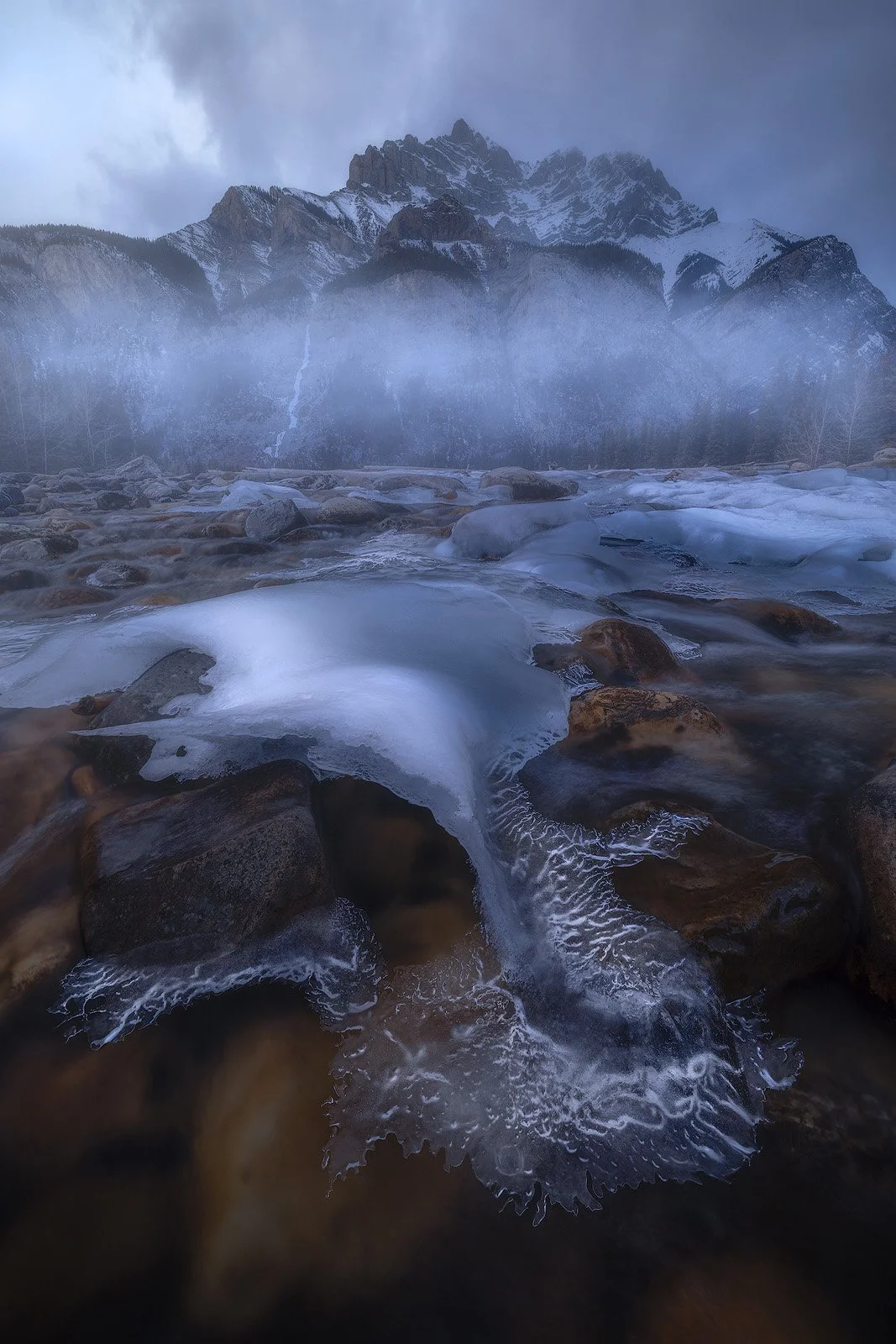 Cascade Pond – Winter mist and frozen river textures beneath rugged mountain peaks.jpg
