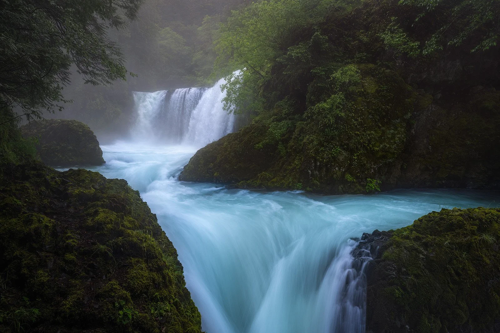 Spirit Falls with Misty Blue Waters and Mossy Riverbanks in Deep Gorge.jpg