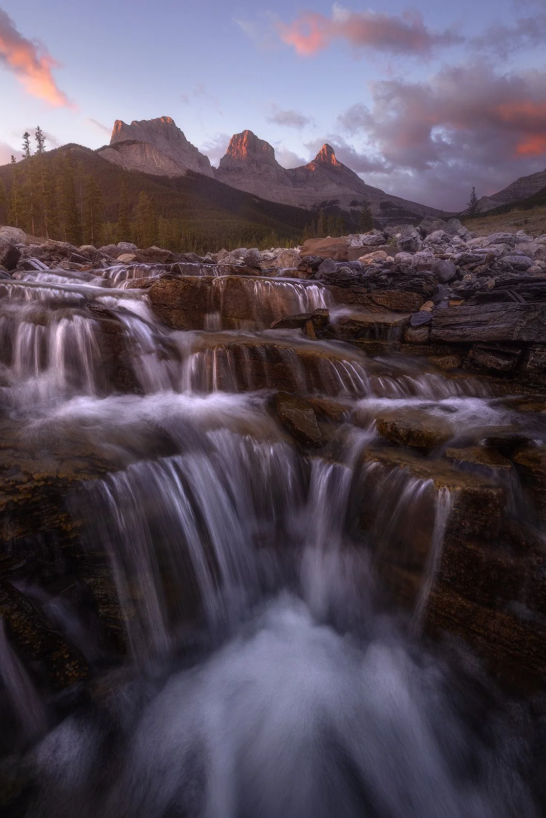 Cascading Waterfall Beneath Three Sisters Peaks at Sunrise.jpg