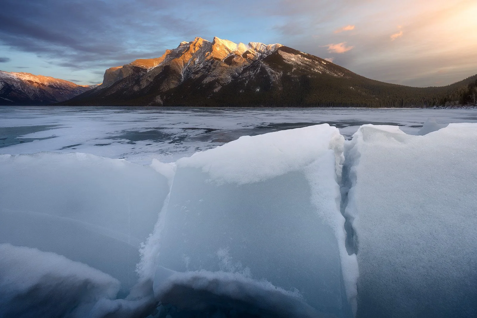 Lake Minnewanka Winter Sunset – Cracked Ice Slabs Beneath Glowing Mountain Range.jpg