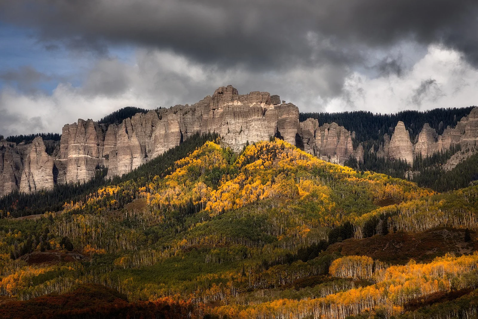 Colorado Cimarron Range – Autumn aspens beneath cathedral spires and moody skies.jpg