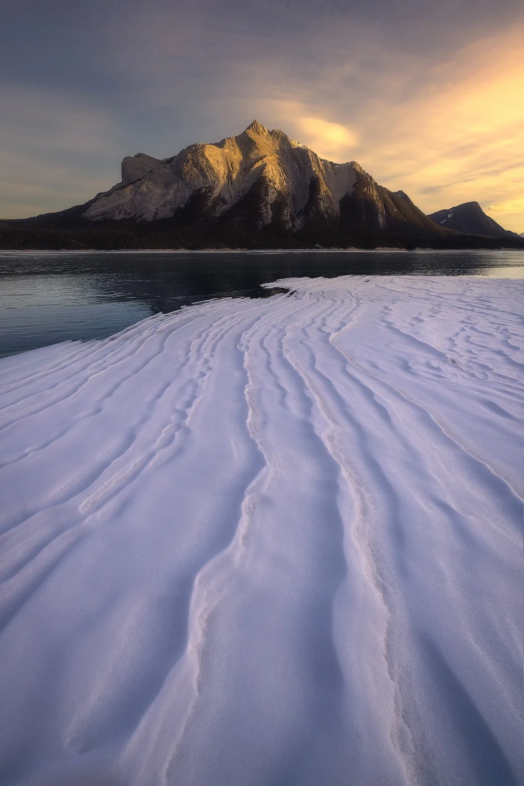 Abraham Lake – Windswept snow textures on frozen lake with sunset light in the Canadian Rockies.jpg