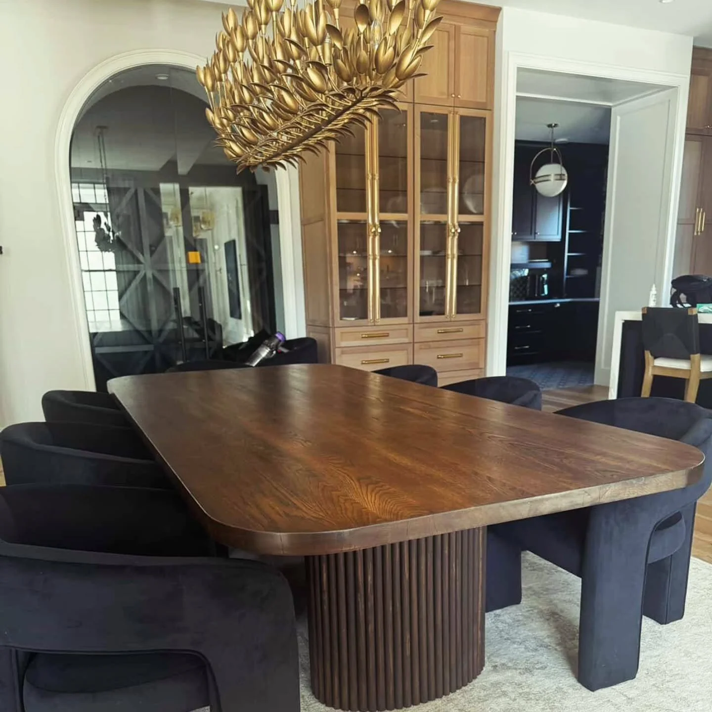 White Oak with fluted bases and dark walnut stain.  Stunning house!