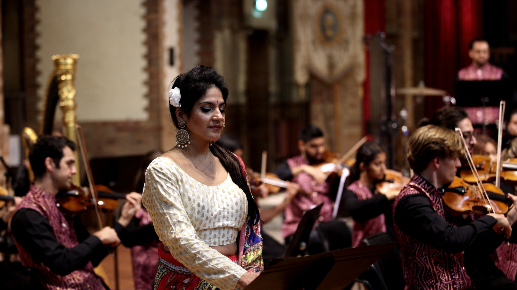 Female singer, orchestra in ornate church