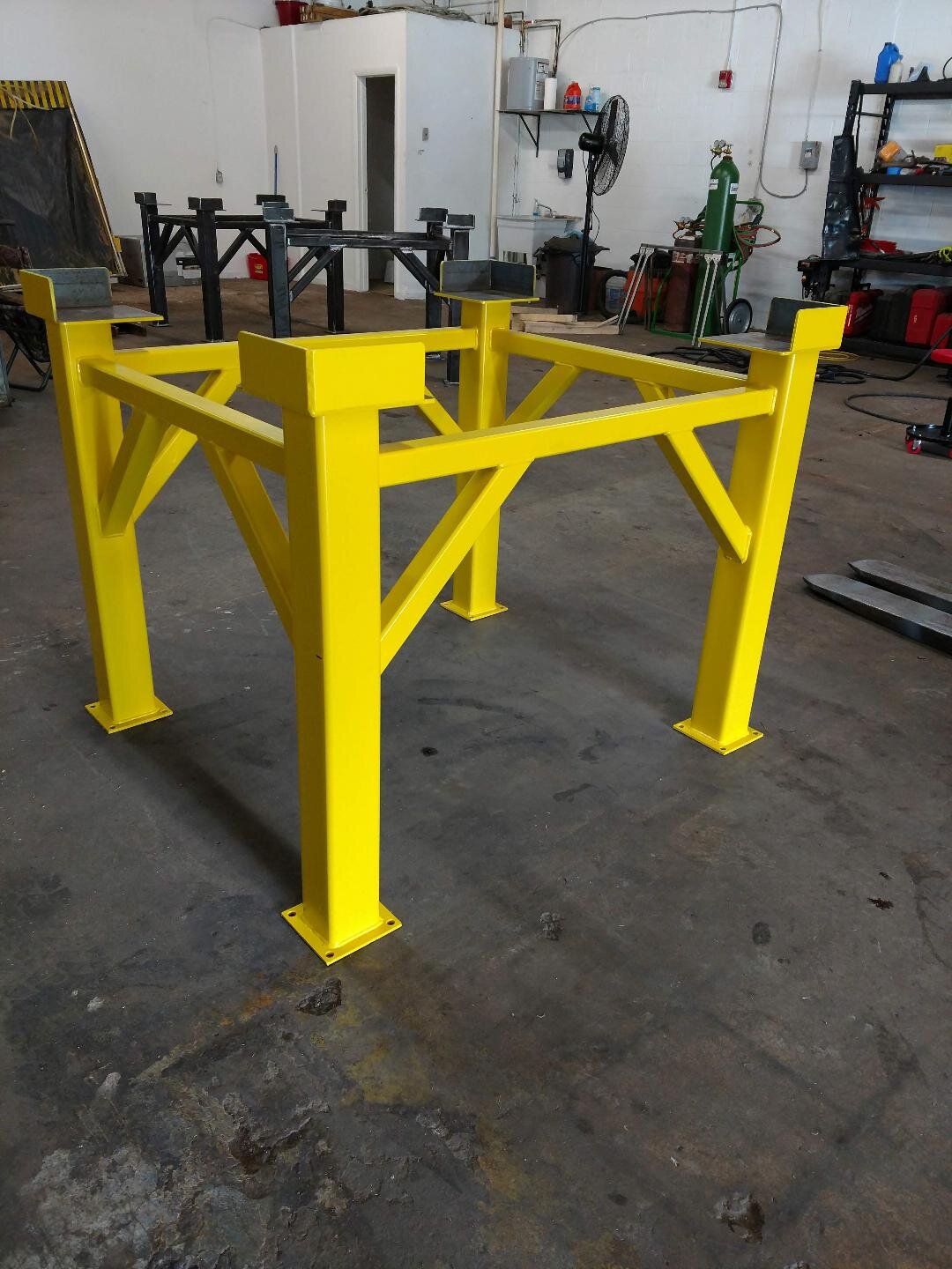 Yellow steel support frame in a workshop setting