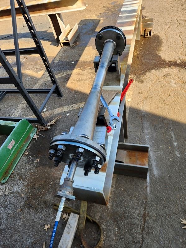 Industrial machinery component on metal beam, outdoor setting