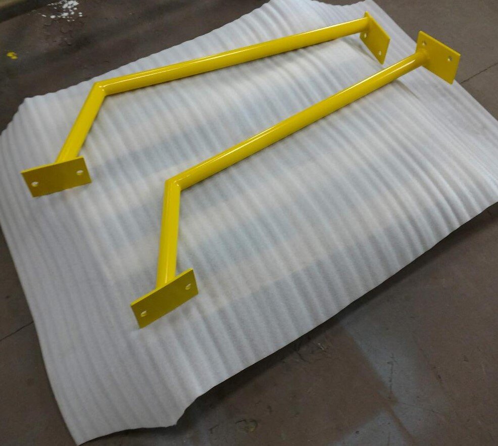 Yellow metal brackets on corrugated packaging