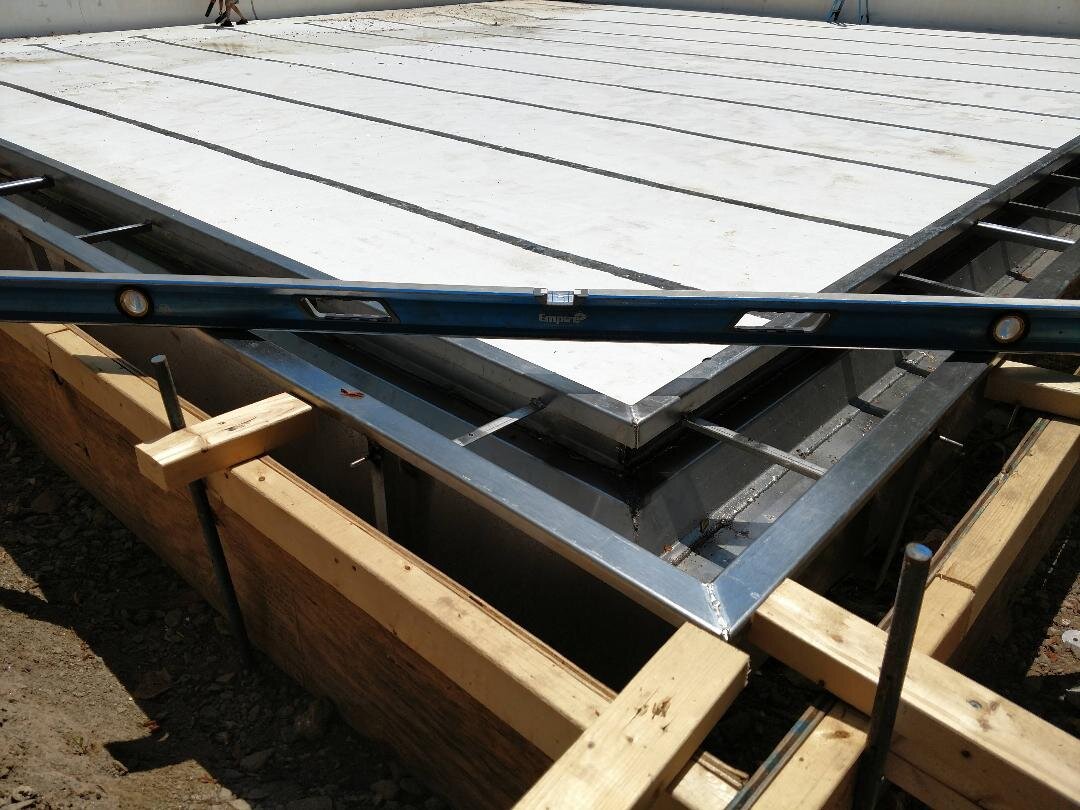 Construction site with wooden forms and metal frame for concrete slab