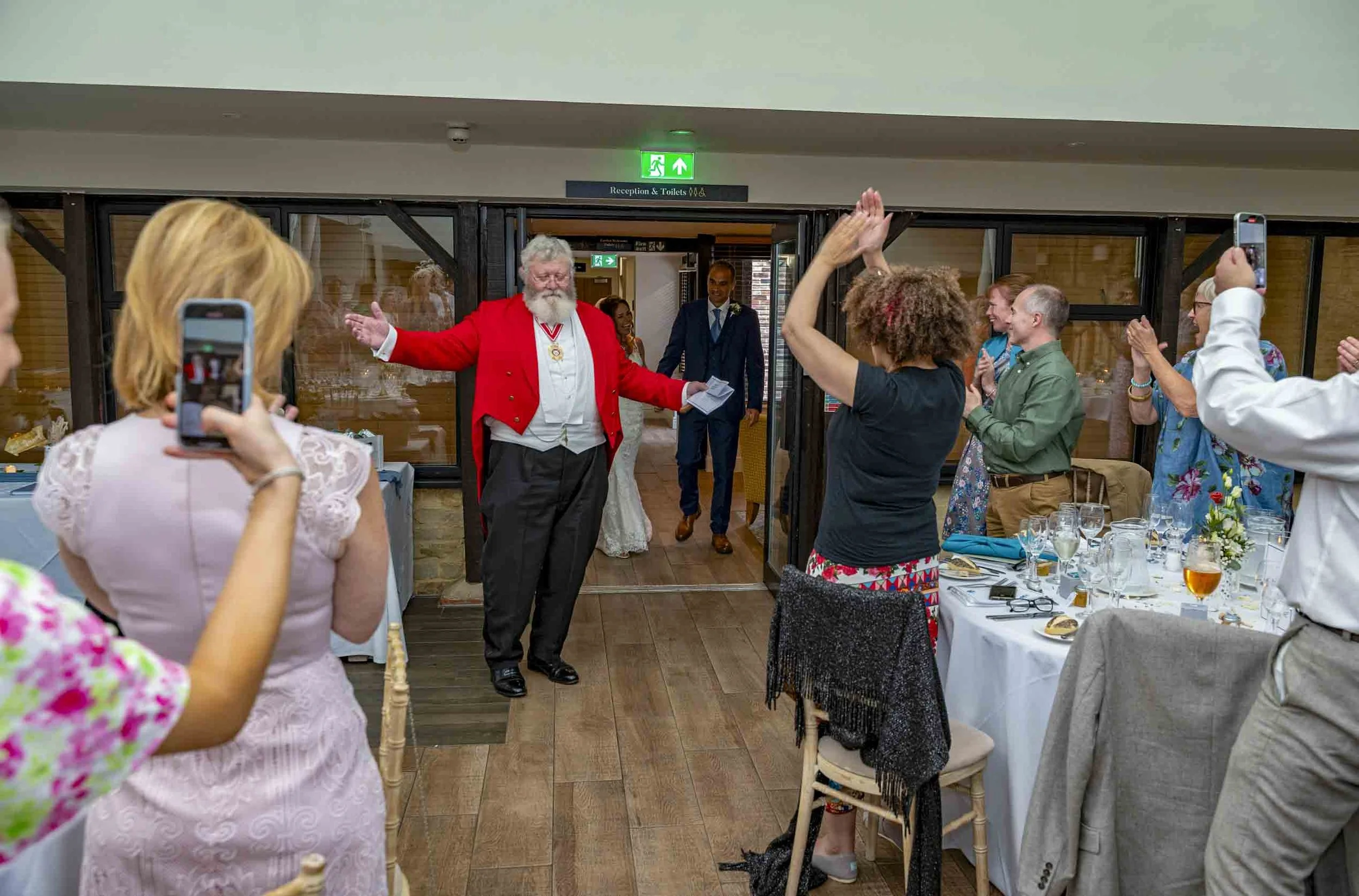 Bride and groom enter a wedding breakfast