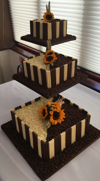 Bi coloured chocolate cigarello cake with sunflowers.PNG