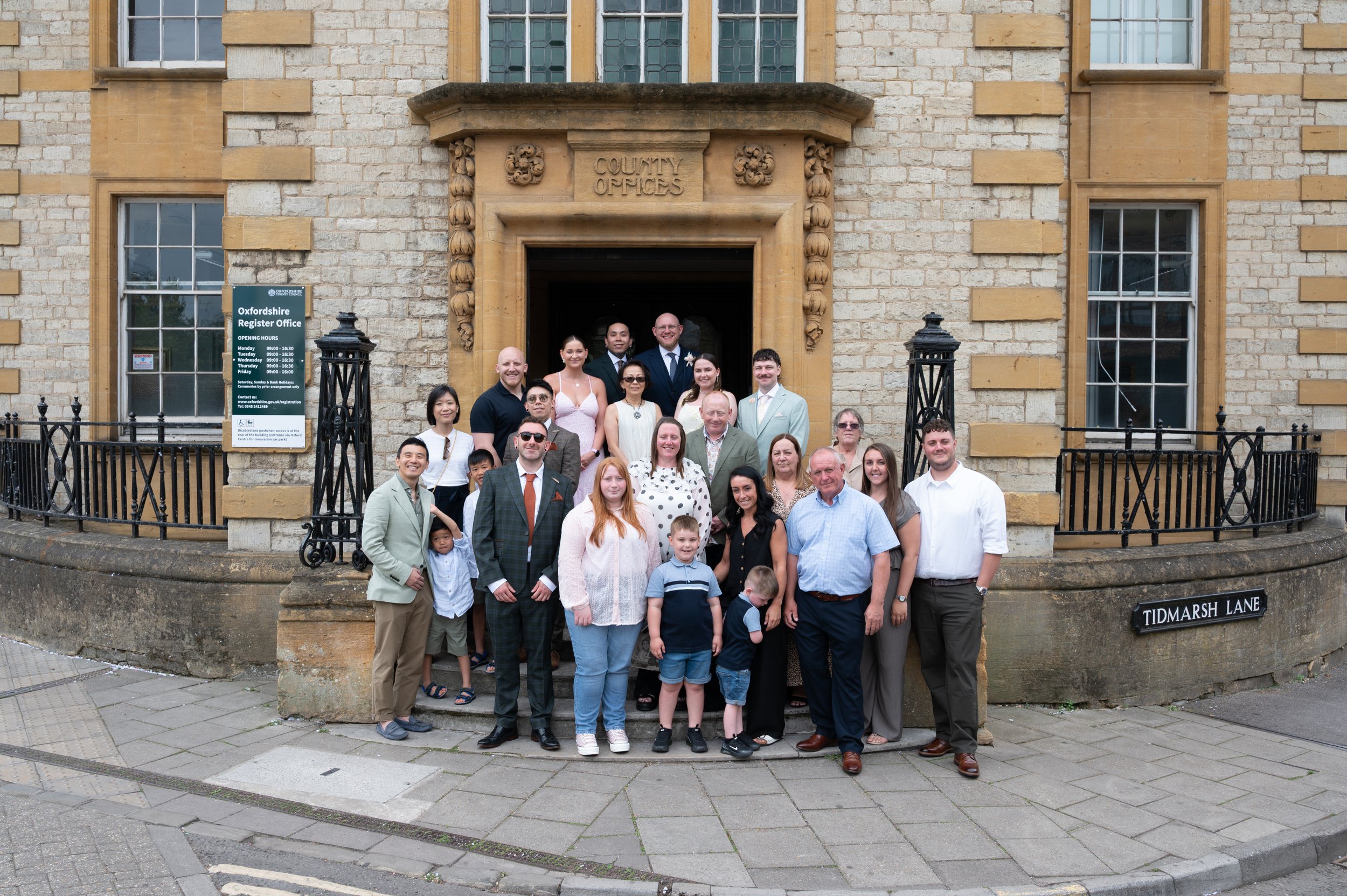 Wedding Guests pose for a photo outside Oxford Registry Office 