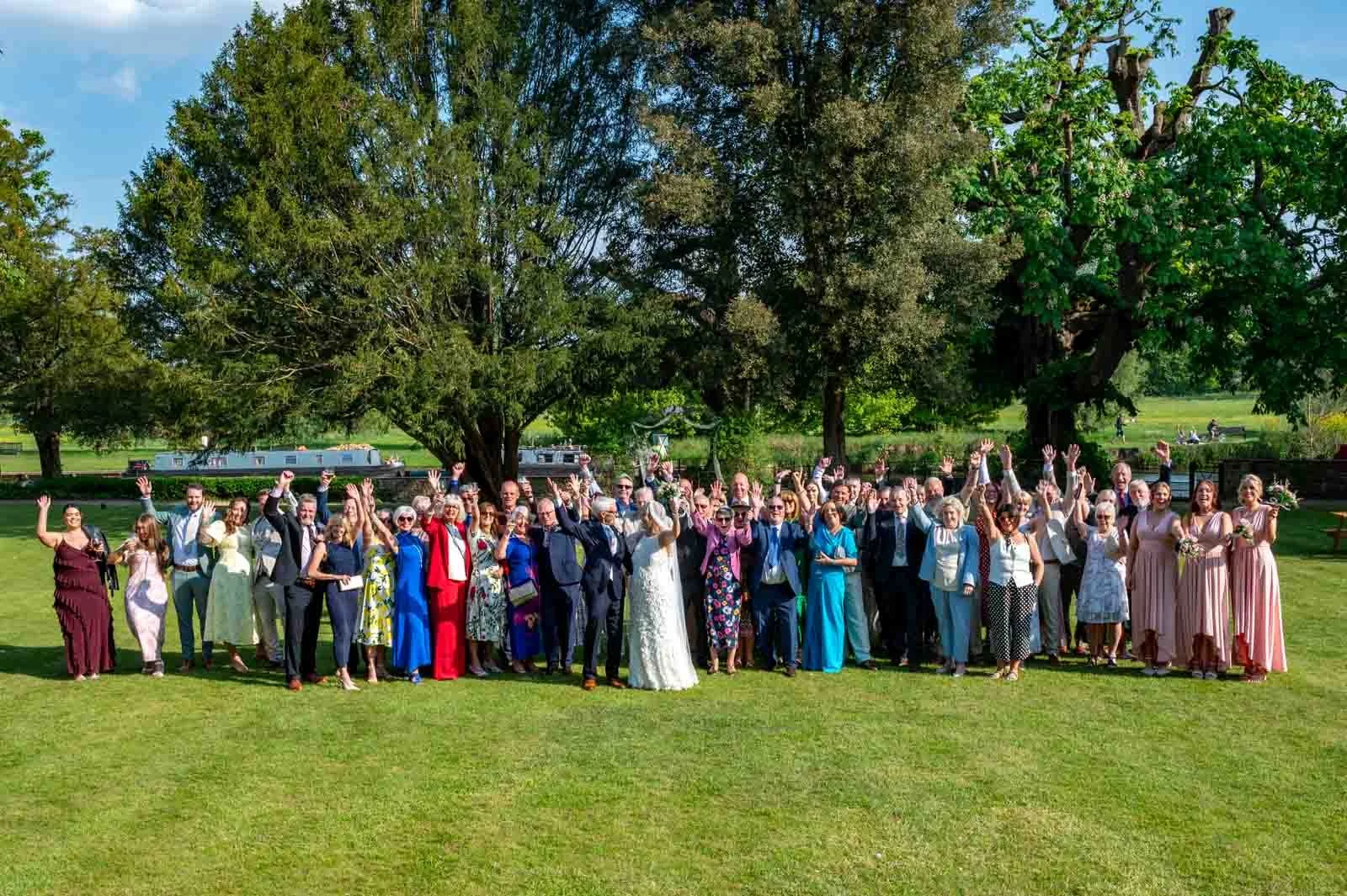 Group wedding photo outside next to the river Thames Abingdon