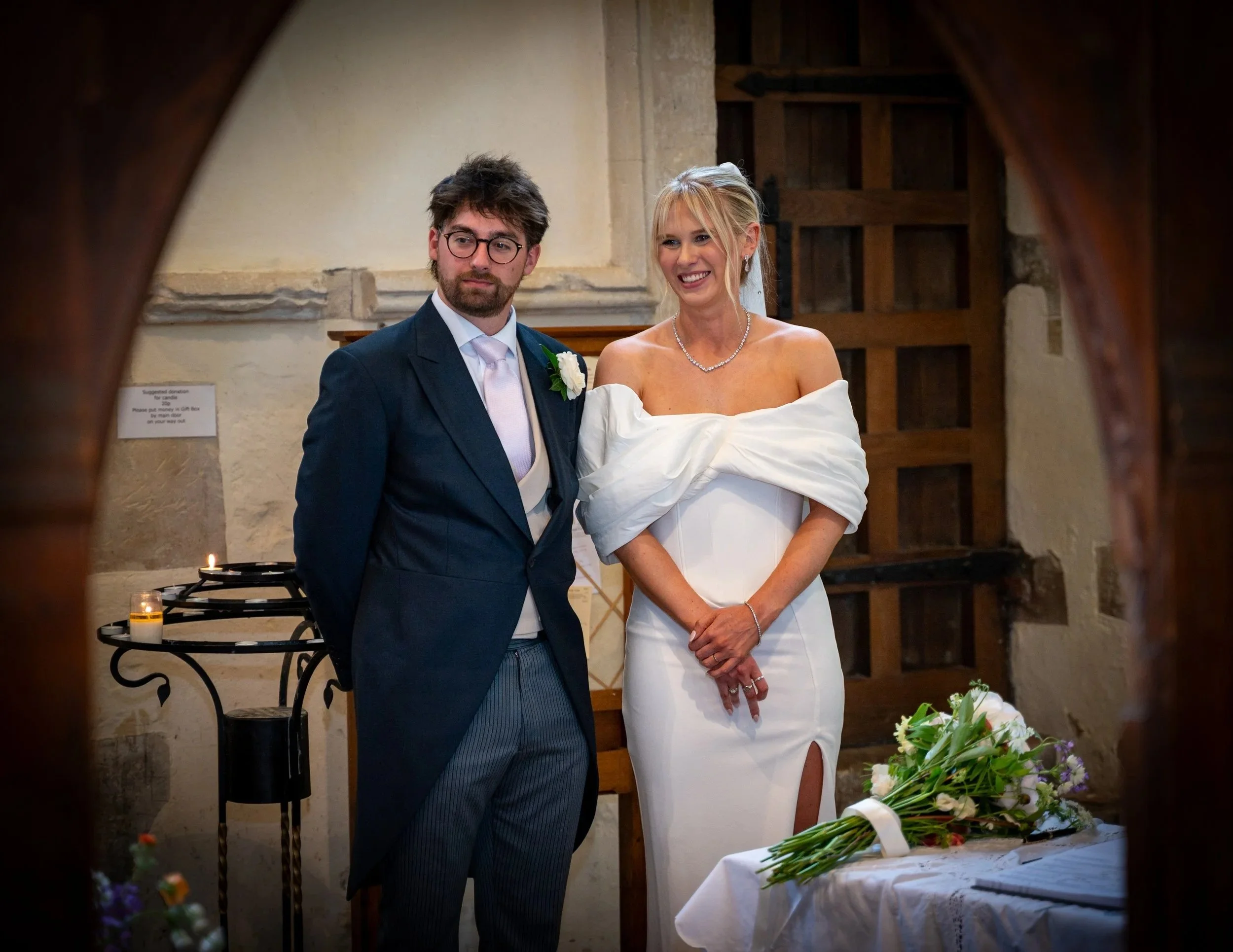 bride and groom stand with each other during their church ceremony