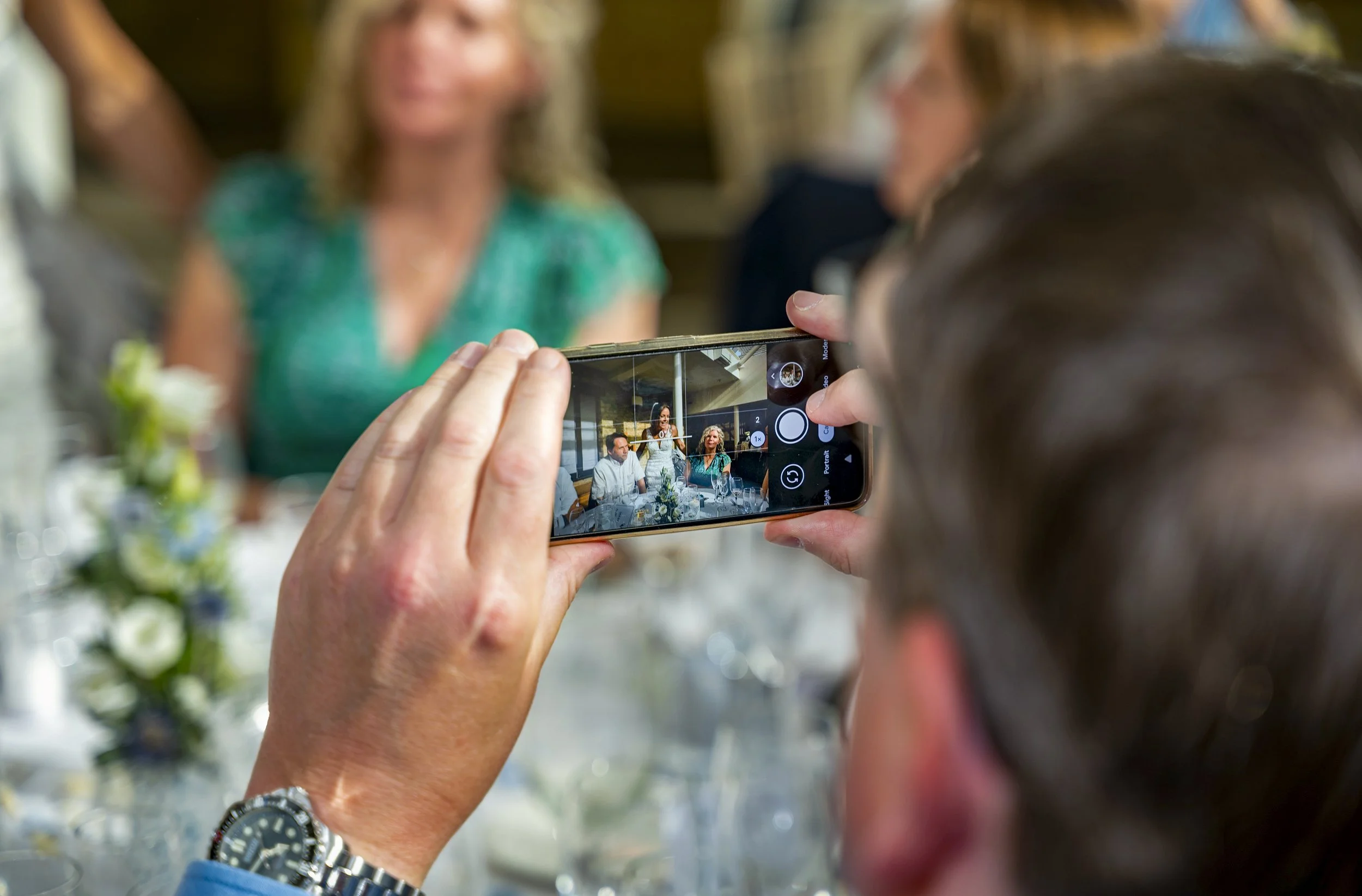 Guest taking photos of wedding party