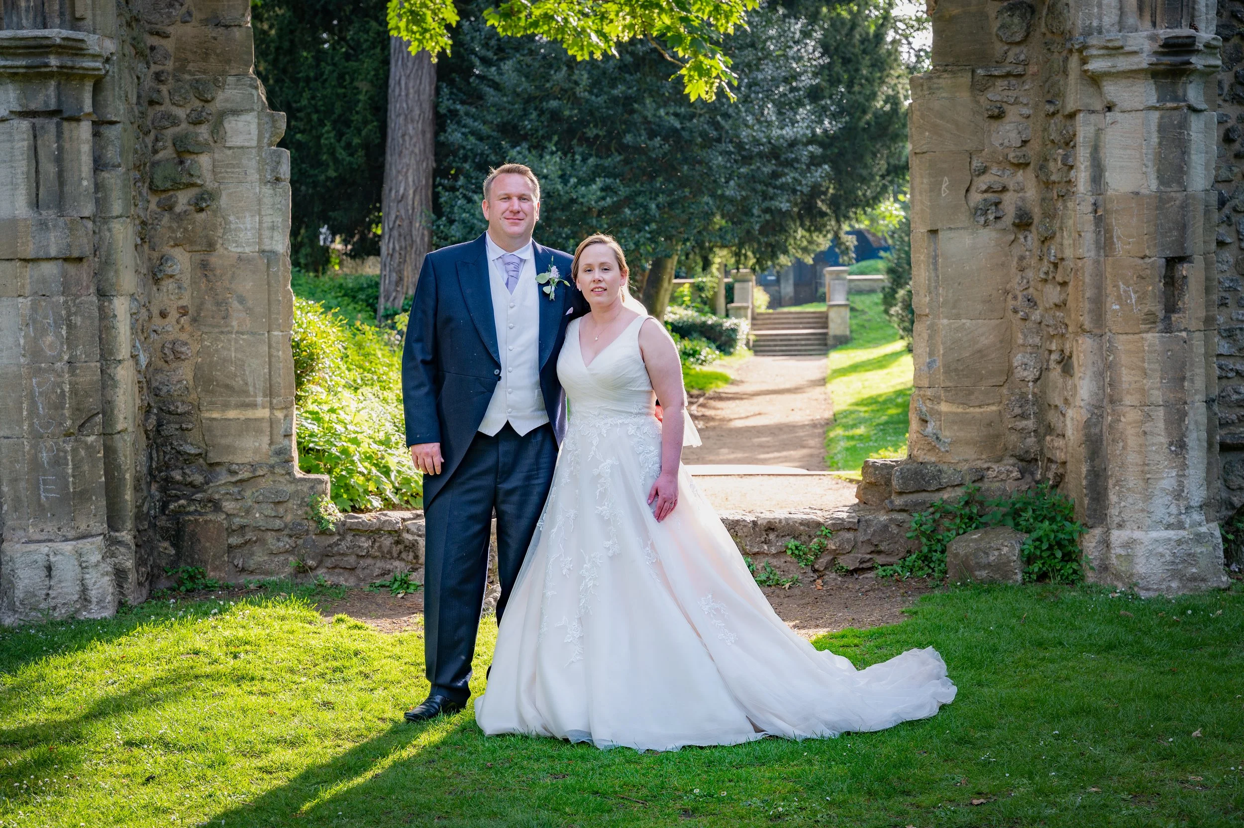 a bride and groom stood at the Abbey Ruins in Abingdon on Thames