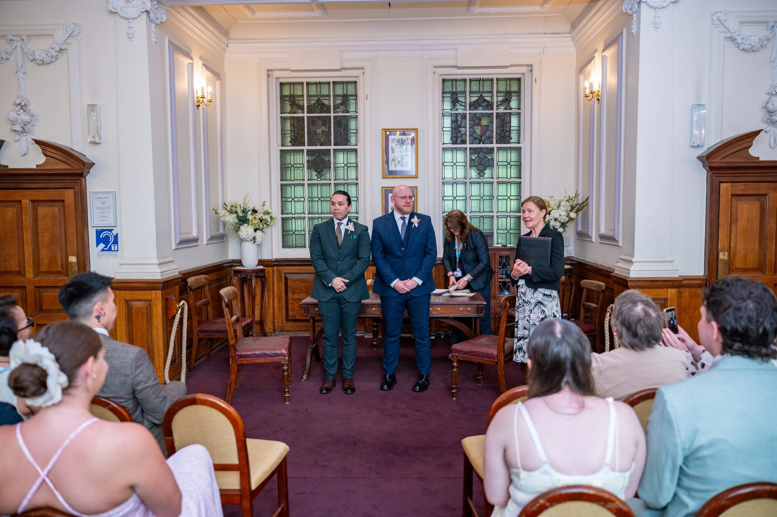 a same sex wedding couple stand in The Dexter Room in Oxfordshire at their ceremony