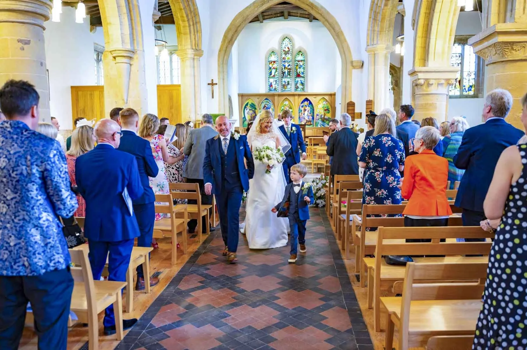 Bride and Groom walk down aisle
